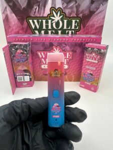 wholemelt vape with branding and packaging
